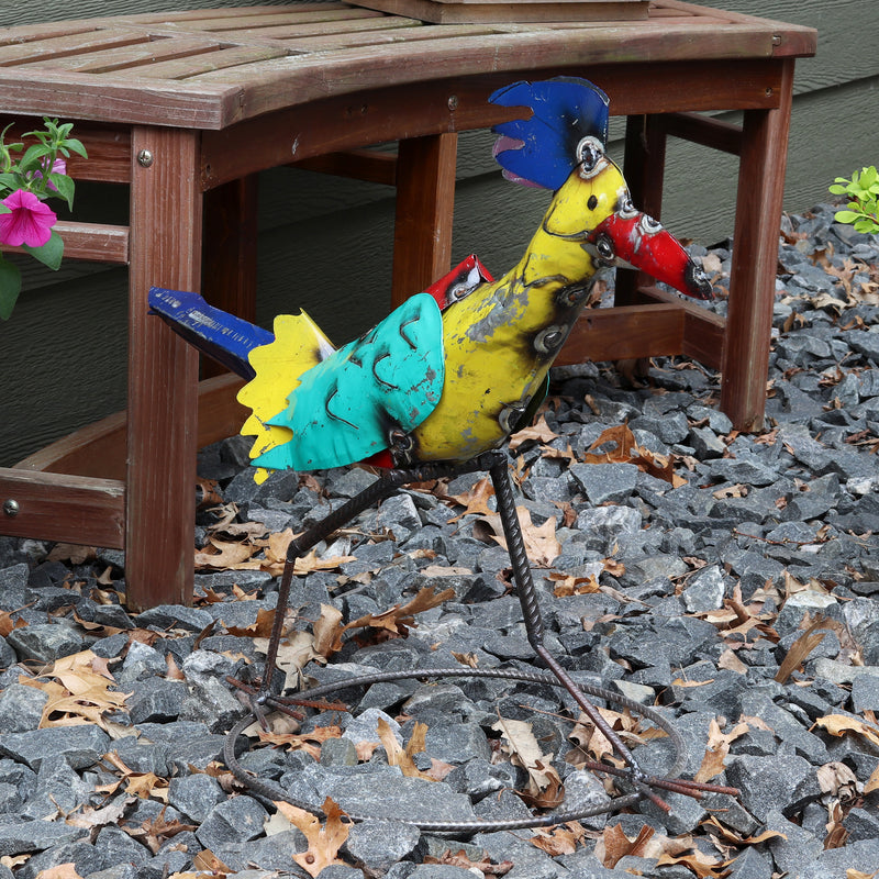Colorful metal bird next to house