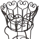 Heart scroll desgin planter with plants in the basket and on the bottom shelf sitting on a patio