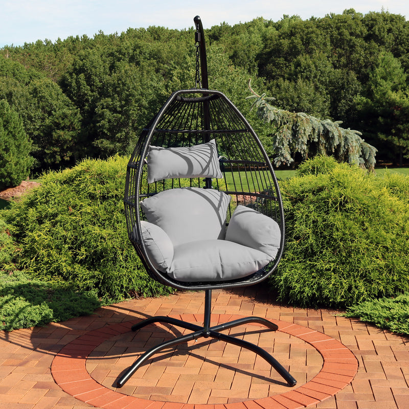 hanging egg chair with gray cushions and black metal stand