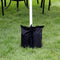 Black polyester sandbag canopy weight anchoring a pop-up canopy