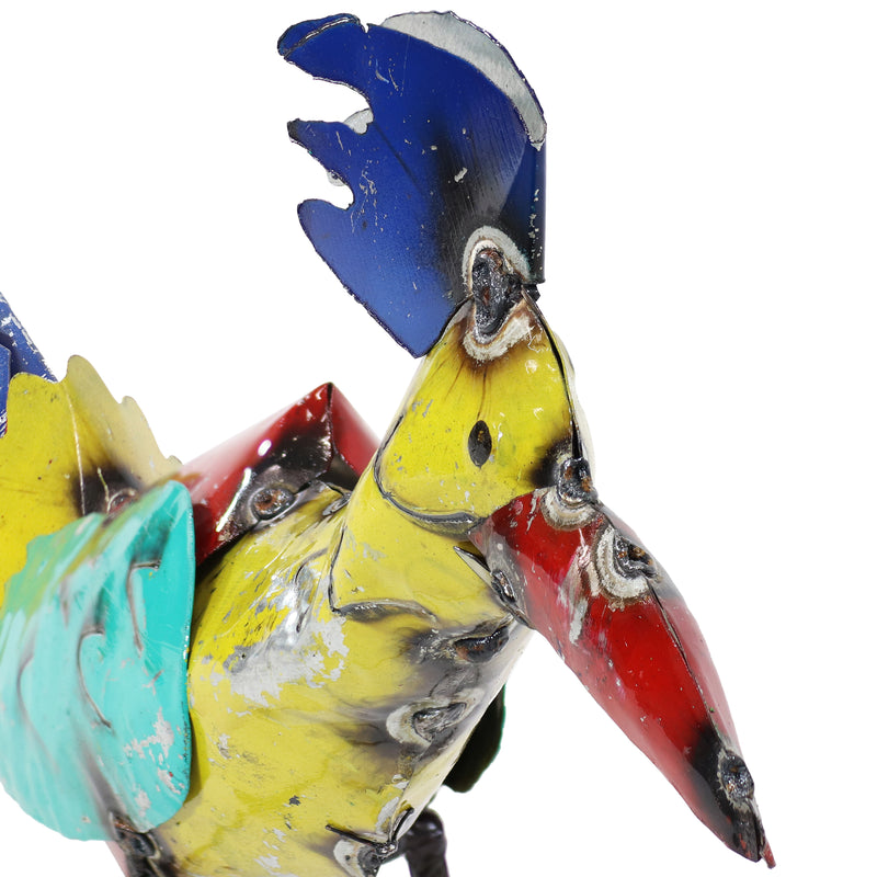 Colorful teal, red, and yellow metal body of roadrunner statue