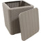 Tan faux rattan storage bin with faux wood lid leaning against the side sitting pool side with a blanket colorful blanket inside.