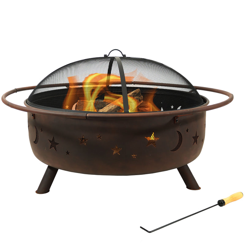 Extra large moon and stars fire pit with spark screen burning wood in the backyard.

